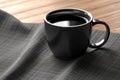 Sleek black coffee mug mockup displayed on a linen napkin Royalty Free Stock Photo