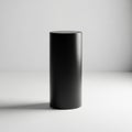 Cylindrical pedestal stands on a smooth, light grey surface. Its Royalty Free Stock Photo