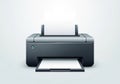 A sleek, black desktop printer with a paper tray extending from the front and paper feeder slots at Royalty Free Stock Photo
