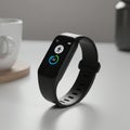 A sleek black fitness tracker with a digital display shows a step counter and activity Royalty Free Stock Photo