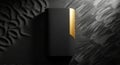 A sleek black and gold rectangular object, possibly a book or device, is placed against a textured Royalty Free Stock Photo