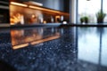 Sleek black granite countertop reflecting warm kitchen lights in a modern interior design Royalty Free Stock Photo