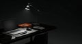 Sleek black marble desktop setup under spotlight Royalty Free Stock Photo
