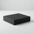 A sleek, black matte cardboard box rests on a smooth, white surface. The box has a Royalty Free Stock Photo