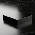 Sleek black rectangular object with dramatic lighting and reflective surface on a dark background Royalty Free Stock Photo