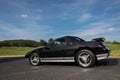 Sleek black and silver sports car with a vibrant blue mural design on the hood