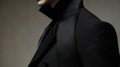 A sleek black suit with a pointed collar and cuffs reminiscent of a vampires cape.