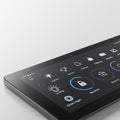 A sleek black tablet displays a home automation interface on its screen. The interface Royalty Free Stock Photo