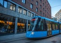 Sleek Blue Tram Rides the Rails Along the Streets of Oslo, Norway