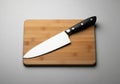 A sleek chef\'s knife with a shiny stainless steel blade and a black handle featuring Royalty Free Stock Photo