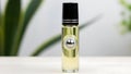 Natural Essential Oil Roll-On Bottle with Green Foliage Background Royalty Free Stock Photo