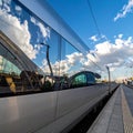 Sleek Commuter Train with Sky Reflection at a Station Royalty Free Stock Photo