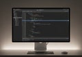 A sleek computer monitor displays code in a dark-themed text editor, featuring syntax highlighting. Royalty Free Stock Photo