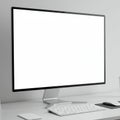 A sleek computer monitor with a thin black frame displays a blank white screen