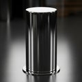 A sleek cylindrical metallic object stands on a dark reflective surface Royalty Free Stock Photo
