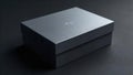 A sleek, dark gray rectangular box rests on a matching surface, subtly textured, ideal for product presentation or minimalist Royalty Free Stock Photo