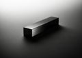 A sleek dark rectangular prism casting a subtle shadow on a white background isolated on white background Royalty Free Stock Photo