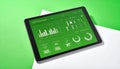 Modern Tablet with Green Data Analytics Dashboard Royalty Free Stock Photo