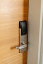 A sleek electronic door lock is installed on a wooden door, showcasing modern technology designed for keyless entry. This lock Royalty Free Stock Photo