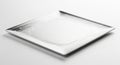 A sleek, futuristic silver plate with a square shape features intricate circuit-like patterns along Royalty Free Stock Photo