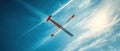 Glider in Flight Under Clear Blue Sky with Wispy Clouds Royalty Free Stock Photo