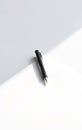 Single Black Pen on White Paper Royalty Free Stock Photo