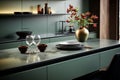Sleek, luxurious kitchen with sage green counter cabinet, sink, and induction