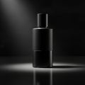 A sleek, matte black bottle stands centered on a reflective surface, illumin Royalty Free Stock Photo