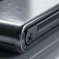 Sleek metallic foldable device closeup with camera lens design Royalty Free Stock Photo