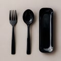 Sleek, minimalist trio black fork, spoon, rectangular tray on neutral background