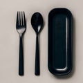 Sleek, minimalist trio black fork, spoon, rectangular tray on neutral background