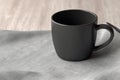 Sleek mockup, black coffee mug on linen napkin Empty cup for promotion Royalty Free Stock Photo