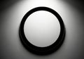 Sleek modern black framed circle on textured grey background with spotlight Royalty Free Stock Photo