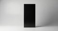 Sleek modern black rectangular object on a light grey surface Royalty Free Stock Photo