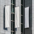 Sleek modern facade with three blank vertical banners, geometric design, windows, shadows Royalty Free Stock Photo