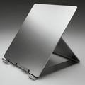 A sleek, modern laptop stand constructed from brushed aluminum. Featuring a Royalty Free Stock Photo
