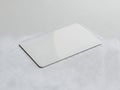 A sleek, modern, minimalist white rectangular object on a textured surface Royalty Free Stock Photo