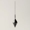 A Sleek and Modern Plumb Bob Hanging Vertically in a Neutral Setting, Showcasing its Streamlined Design and Royalty Free Stock Photo