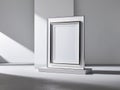 Sleek modern poster frame rectanguler in shape standing on the white wall Royalty Free Stock Photo