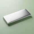 A sleek, modern silver rectangular box on a muted green background Royalty Free Stock Photo