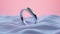 Modern silver ring on textured surface with soft pink background Royalty Free Stock Photo