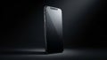 Sleek modern smartphone with a dark reflective screen and metallic silver frame isolated on a dark background Royalty Free Stock Photo
