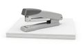 A sleek modern stapler resting on top of a stack of white paper Royalty Free Stock Photo