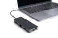 Black usb-hub connected to a modern laptop on white Royalty Free Stock Photo