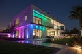 Modern villa with colored LED lights at night Royalty Free Stock Photo