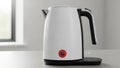 Sleek modern white electric kettle with a black handle and illuminated red power button Royalty Free Stock Photo
