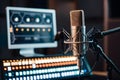 Sleek recording setup with microphone, monitor, and illuminated controls for precision Royalty Free Stock Photo