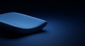 A sleek, rectangular object with smooth, rounded edges is illuminated by a soft blue Royalty Free Stock Photo