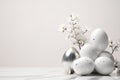 Sleek Silver egg with White Floral Accents Among Speckled Eggs for a Refined Easter Banner in Monochrome Shades