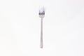 Sleek Silver Fork Elegantly Placed on a Pure White Canvas Demonstrates Culinary Precision and Design Simplicity for a Refreshing Royalty Free Stock Photo